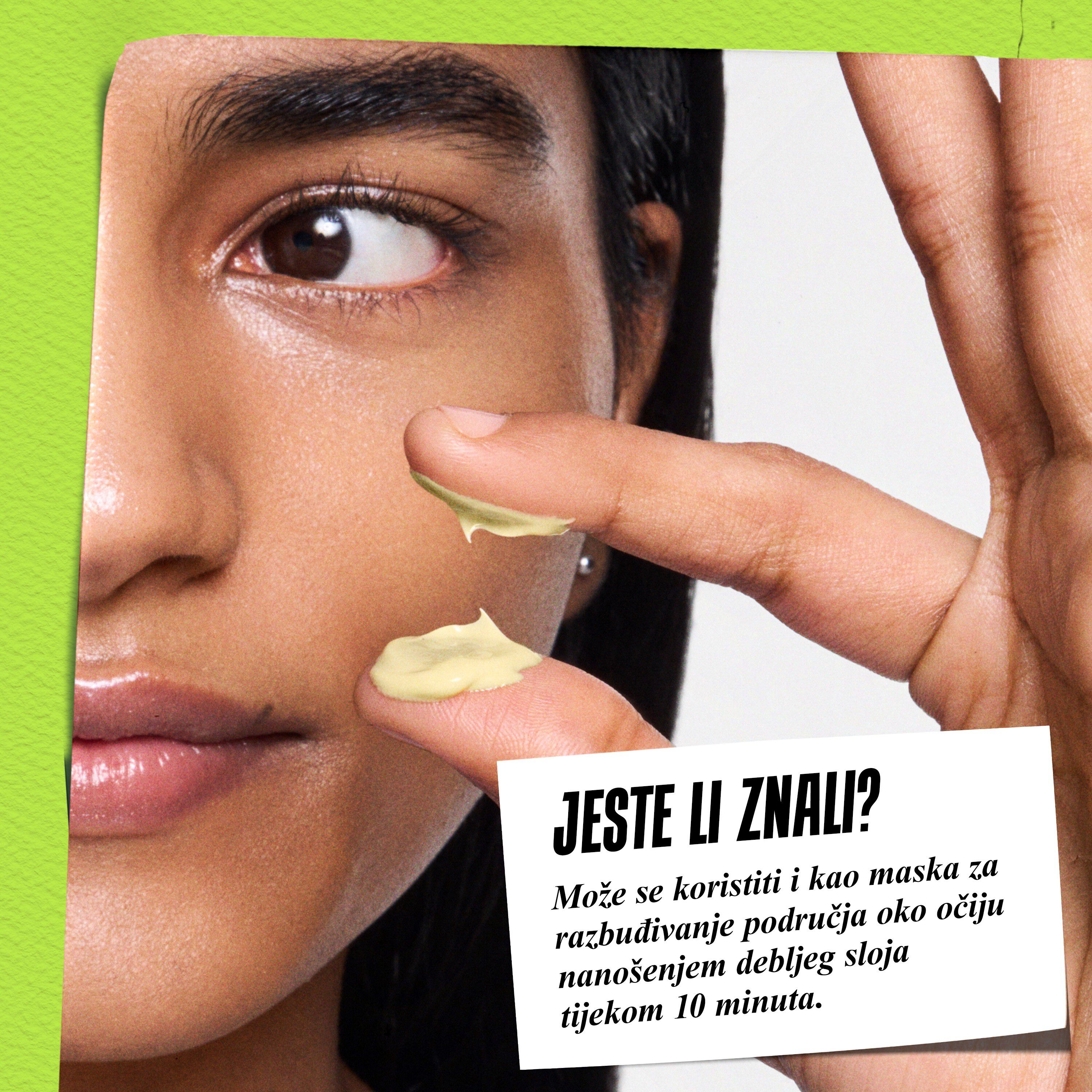 Model drži posudicu Kiehl's Creamy Eye Treatment with Avocado