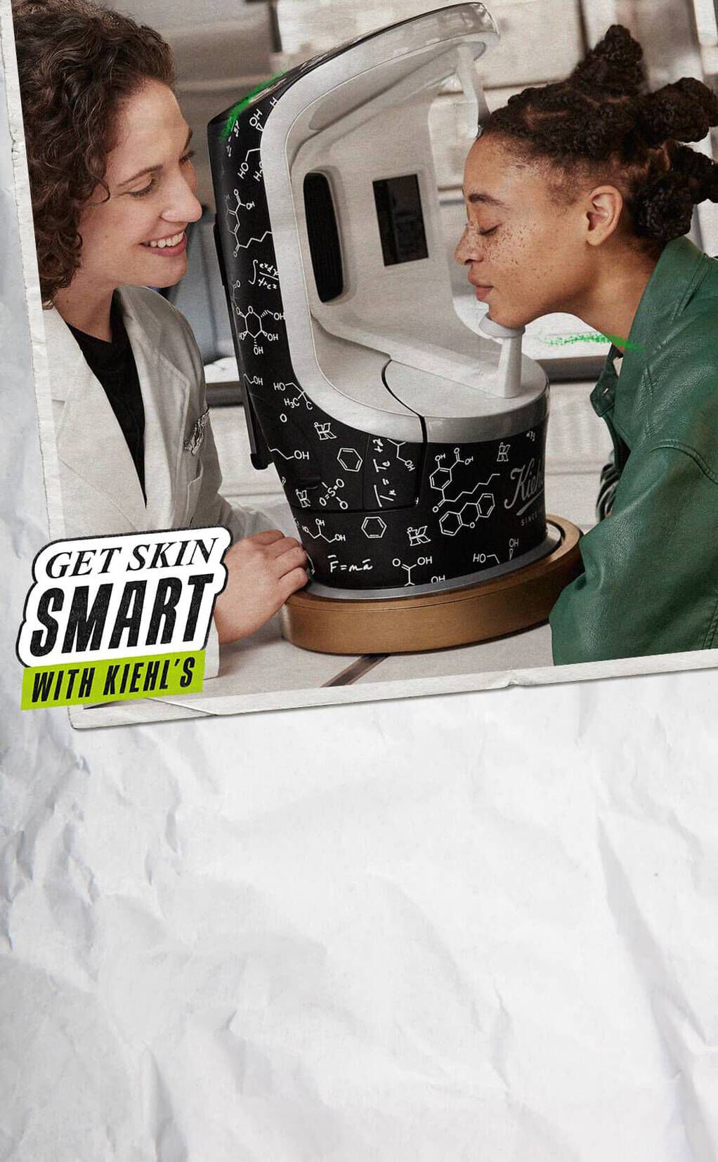 Dva lica se smiju dok istražuju kožne proizvode u modernom uređaju, s natpisom "Get Skin Smart with Kiehl's".